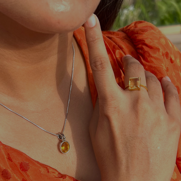 A girl wearing beautiful natural golden topaz ring and a pendant